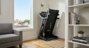 A compact mid-range treadmill under $1000 folded up neatly in the corner of a studio apartment.