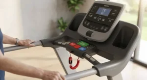 Close-up of a senior-friendly low step-on treadmill display console with large high-contrast buttons and an emergency safety clip.